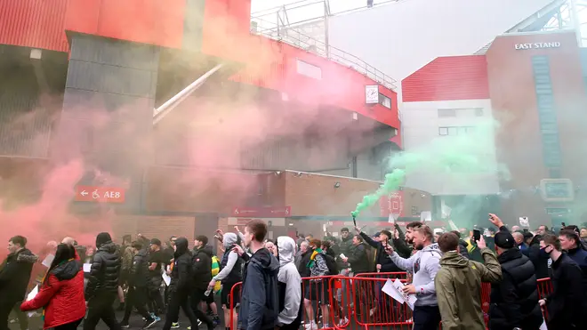Fans break through the barriers outside Old Trafford before storming the stadium