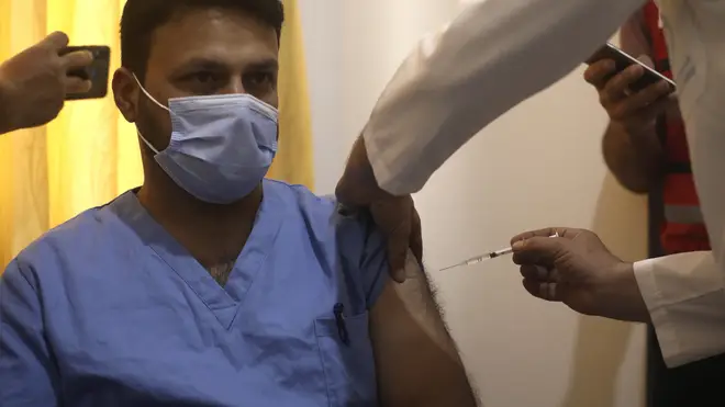 A Syrian nurse receives AstraZeneca COVID-19 vaccine in Idlib, Syria (Ghaith Alsayed/AP)