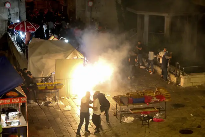 A stun grenade explodes during clashes amid tension outside the Damascus Gate of Jerusalem's Old City.