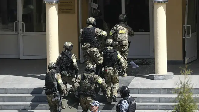 Armed police attend the scene of a school shooting in Russia