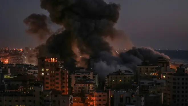Thick smoke billows from Hanadi residential tower in Gaza after it was hit by an Israeli airstrike