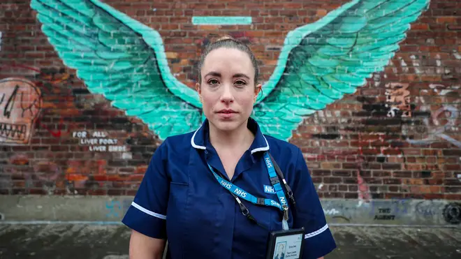 District Nurse team leader Erica Daly, at Mersey Care NHS, as she stands in front of the 'Liver Bird Wings
