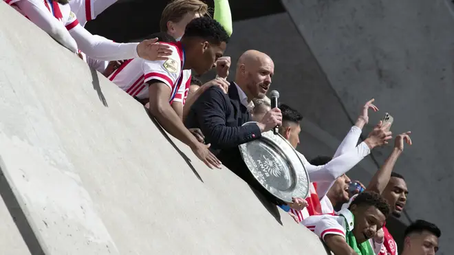 Ajax coach Erik ten Hag and players hold the trophy as they celebrate clinching the Dutch Eredivisie Premier League title at the Johan Cruyff ArenA in Amsterdam, Netherlands