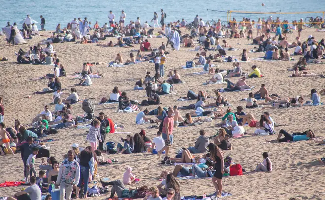 A crowd of people seen on the beach of Barceloneta in Barcelona, Spain
