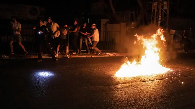 Molotov cocktails are thrown at Jewish right-wing protesters during clashes in the Israeli city of oLd