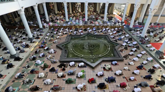 Muslims pray spaced apart to help curb the spread of coronavirus outbreak during an Eid al-Fitr prayer marking the end of Ramadan at Al Akbar mosque in Surabaya, East Java