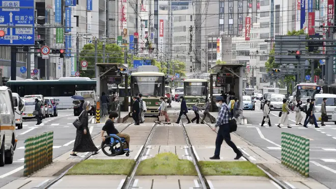 People wearing face masks make their way in Hiroshima, western Japan
