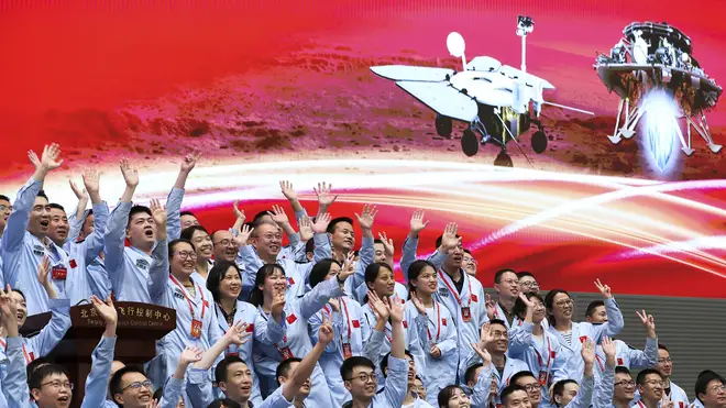 Members at the Beijing Aerospace Control Centre celebrate