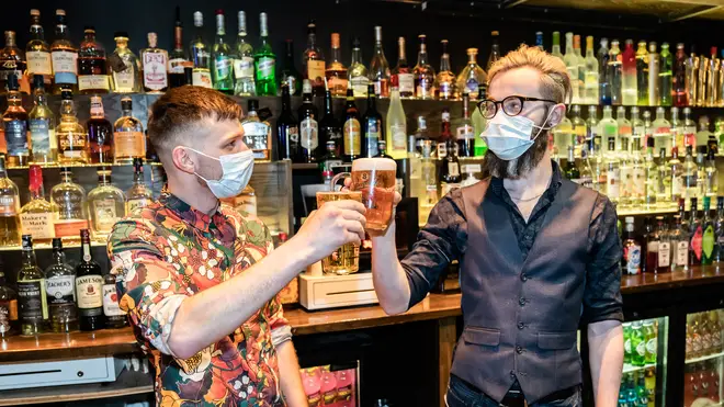 Bar staff celebrate the indoor reopening of a pub in Huddersfield