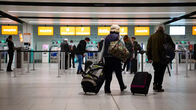 Passengers check in for the first holiday and leisure flight to take-off at Gatwick Airport