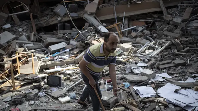 A Palestinian man inspects the damage of a house destroyed by an early morning Israeli airstrike, in Gaza City