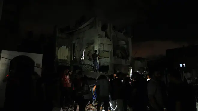 Palestinians rushed to pull bodies and possessions from the rubble of destroyed homes along the Gaza Strip