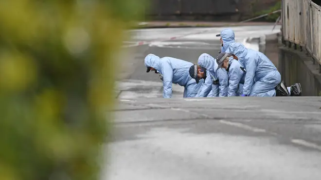 Forensic officers carry out searches in Peckham after the shooting