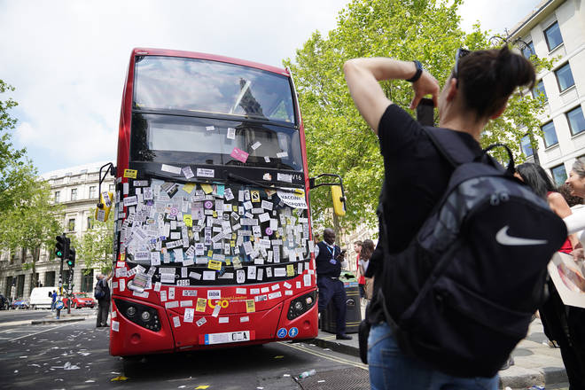 A London bus was covered in anti-vaccination stickers during the protests