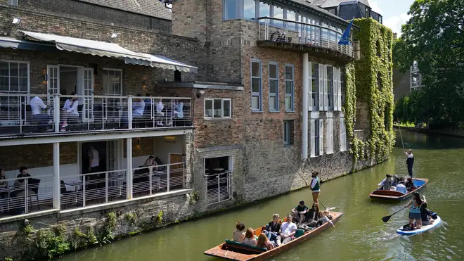 Punts floated past pubs in Cambridge during the bank holiday weekend