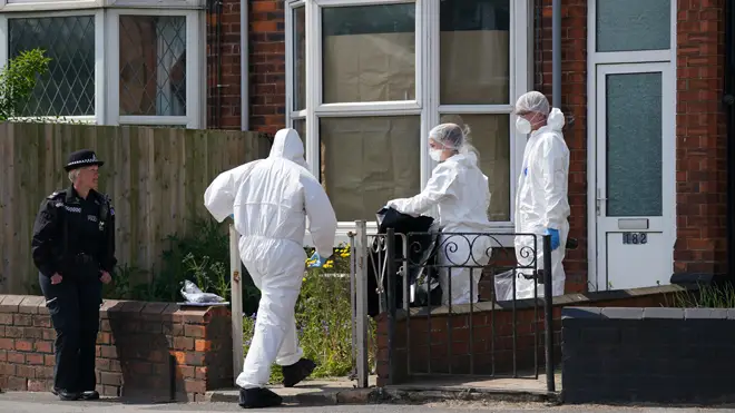 Forensics officers in Lincolnshire after the deaths of a woman and child