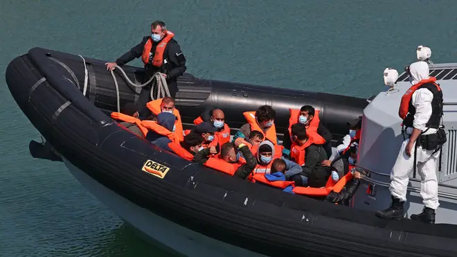 A group of people thought to be migrants are brought in to Dover, Kent, on Thursday