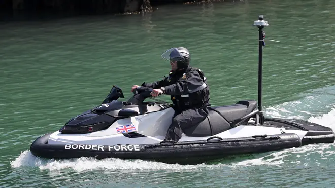 A Border Force officer arrives on a jet ski into Dover