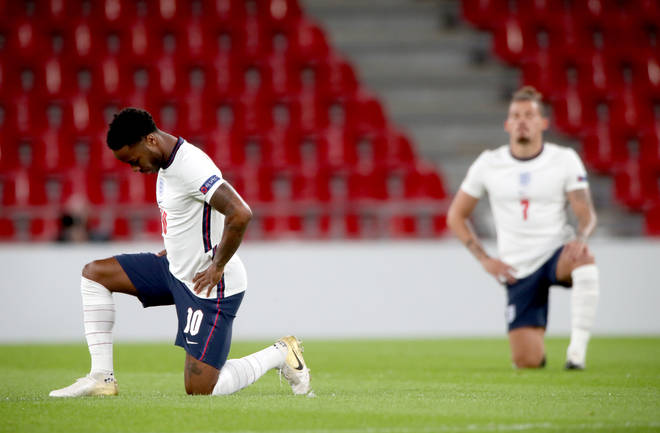 England's Raheem Sterling (left) and Kalvin Phillips take the knee ahead of a match.