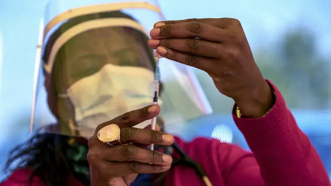A health worker prepares a dose of the Pfizer coronavirus vaccine
