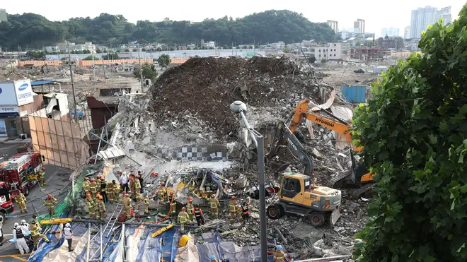 Firefighters search for survivors in a collapsed building in Gwangju, South Korea (Chung Hoi-sung/AP)