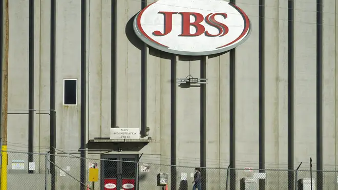A worker heads into the JBS meatpacking plant in Greeley, Colorado