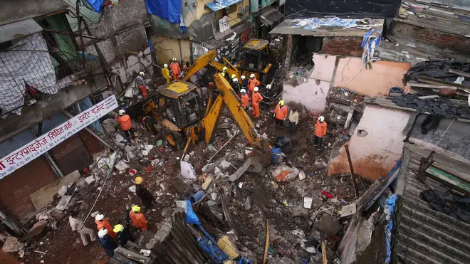 Rescuers clear debris after a building collapsed in Mumbai