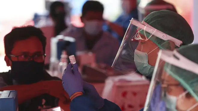 Health workers prepare doses of the AstraZeneca vaccine in Jakarta