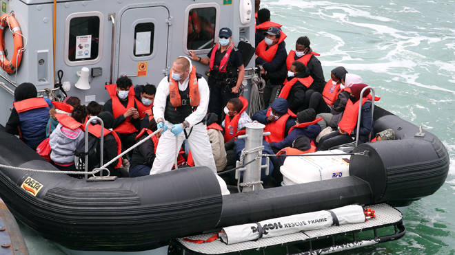 A group of people are brought to shore in to Dover