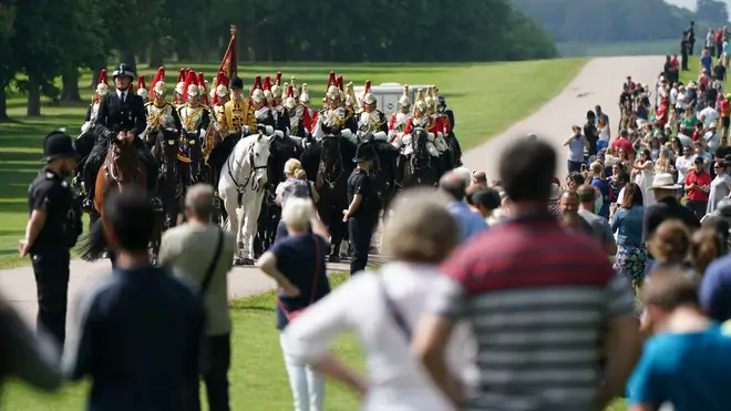 Members of the Household Cavalry make their way down the Long Walk towards Windsor Castle