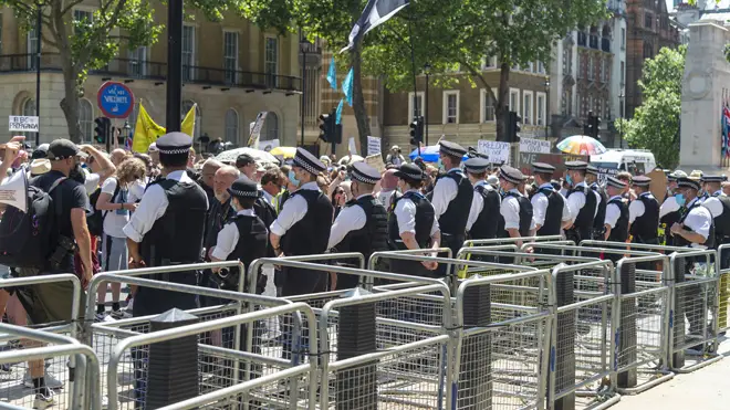 A line of police at the anti-lockdown protest at Downing St on Monday