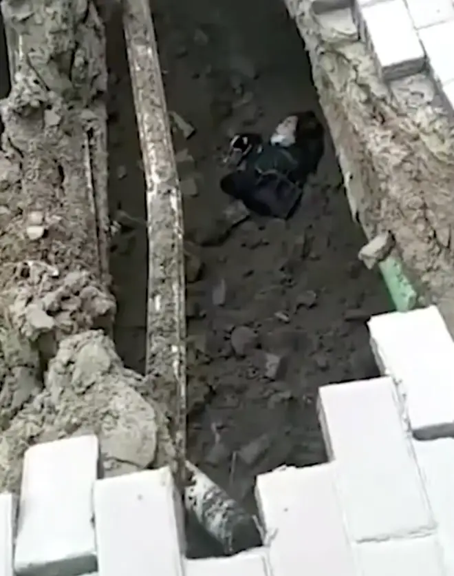A woman was swallowed by a sinkhole that opened up on the pavement beneath her feet