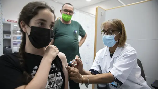 A woman receiving a vaccination