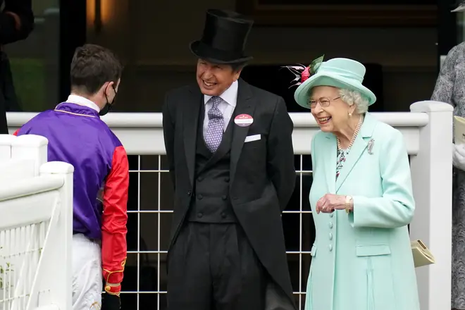 Queen Elizabeth II and racing manager John Warren (centre) speak with jockey Oisin Murphy