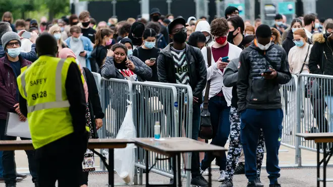 People queue for a vaccine outside the London Stadium