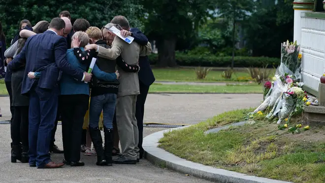 The families of the three victims of the terror attack at Forbury Gardens hug each other