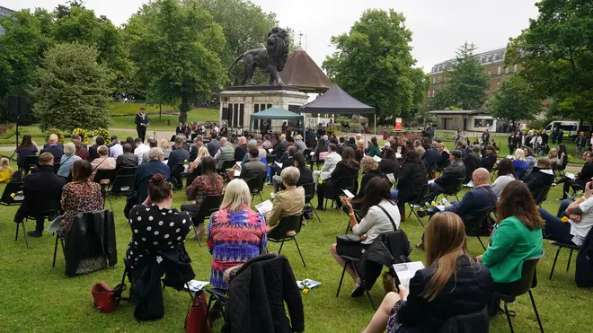 People attend the memorial service at Forbury Gardens bandstand