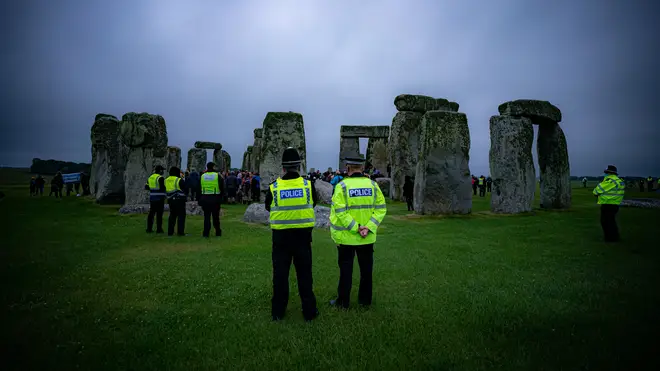 Police attend as crowds celebrate during Summer Solstice at Stonehenge