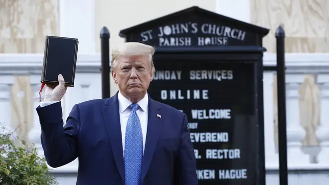 Donald Trump holds a Bible outside St John’s Church