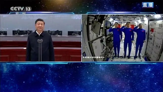 Composite pic showing Chinese astronauts saluting as they talk with Chinese President Xi Jinping