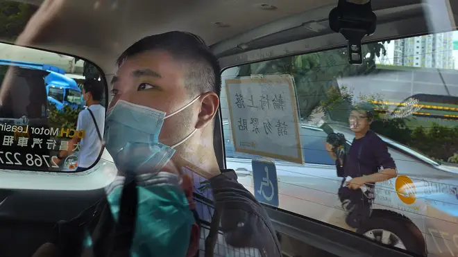 In this July 6, 2020, file photo, Tong Ying-kit arrives at a court in a police van in Hong Kong