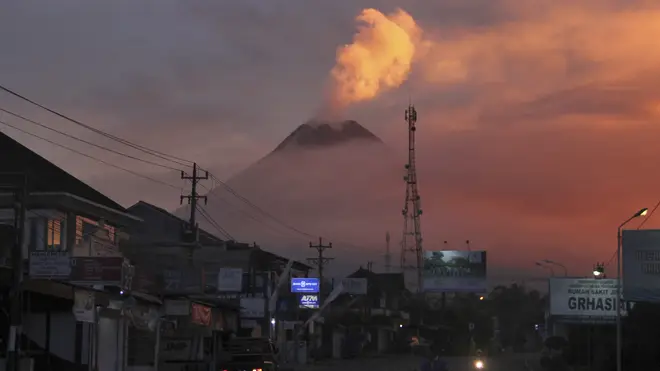 Indonesia’s most volatile volcano erupted Friday, releasing plumes of ash high into the air and sending streams of lava with searing gas clouds flowing down its slopes