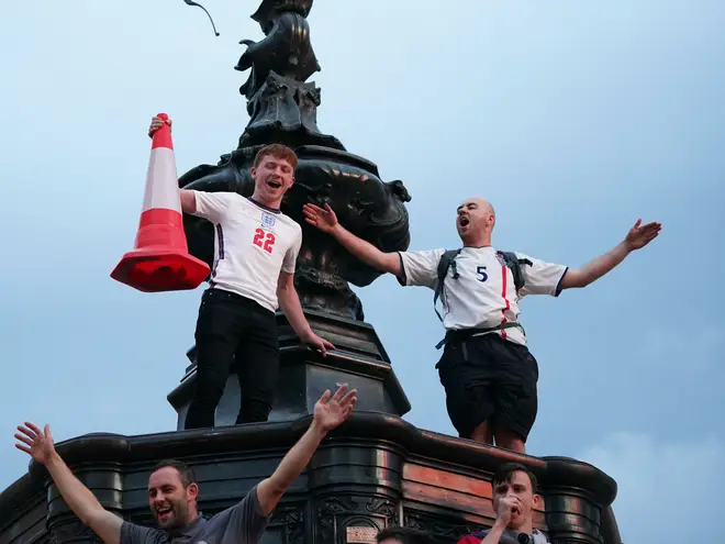 England supporters climbed up on to the Shaftesbury Fountain in Piccadilly Circus