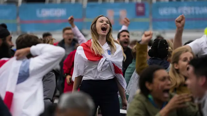 An England fan celebrates during the side's 2-0 win