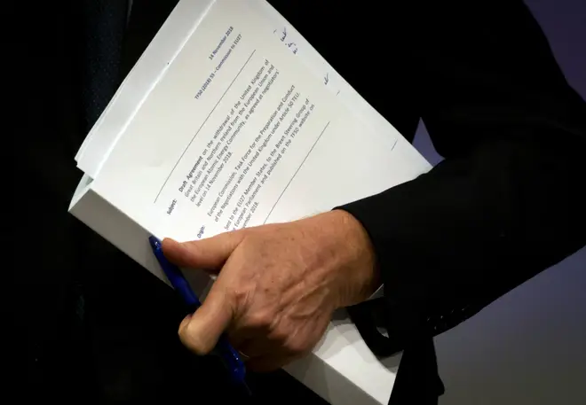 Michel Barnier holds the draft EU withdrawal agreement
