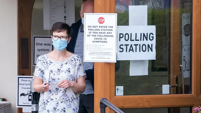 A voter leaves a polling station after placing her ballot in the Batley and Spen by-election