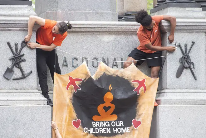 Protesters raised a banner in protest at the treatment of Indigenous children in Canada