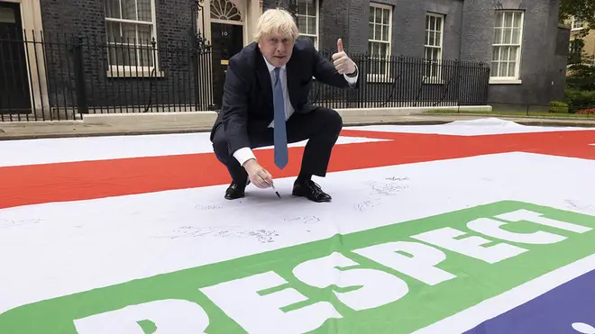 Boris Johnson appeared to sign the giant England flag