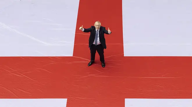 The PM posed in the centre of the flag of St George with his thumbs up