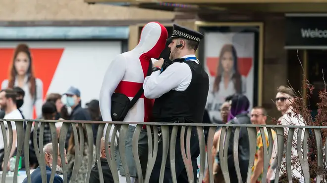 A police officer speaks to an England fan ahead of the quarter-final with Ukraine last Sunday.